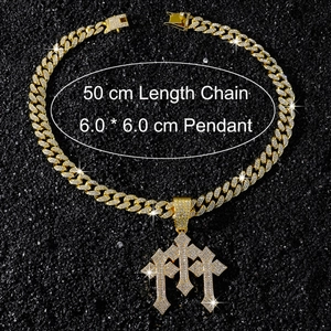 Macro view of iced-out triple cross pendant with 50cm golden Cuban link chain