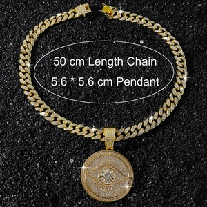 Macro view of iced out hip hop devil eye pendant with golden Cuban chain details