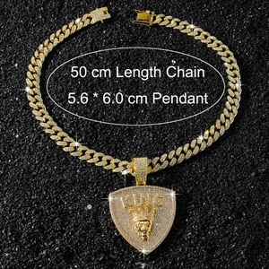 Detail of gold Cuban chain and lion head pendant with dimensions 5.6x6.0 cm