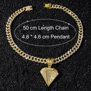 Detail view of 50cm golden hip hop chain with 4.6cm iced out diamond pendant on black sand