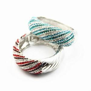 Exaggerated silver alloy wide bangles with spiraled red and blue rhinestones inlay
