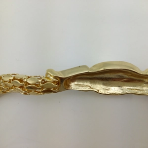 Golden snake chain bracelet featuring a lion head design and diamond-encrusted details