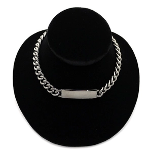 Detail shot of silver alloy curb chain necklace with a smooth rectangular ID plate on a display