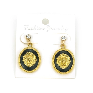 Detail of golden lion head earrings with black enamel and white crystal studs