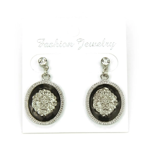 Detail of silver lion head earrings with black enamel base and sparkling rhinestones