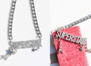 Detail of silver chain necklace with crystal SUPERSTAR pendant and Eiffel Tower charm