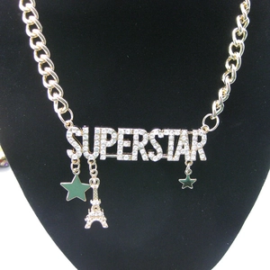 Gold-tone superstar letter necklace with rhinestone charms and Eiffel Tower pendant