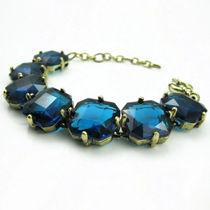 Vintage gold alloy bracelet with emerald-cut blue crystals and adjustable lobster clasp
