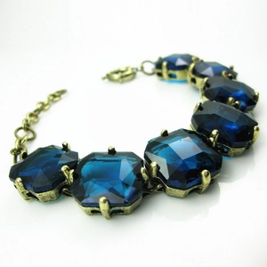 Vintage gold alloy bracelet with emerald-cut blue crystals and adjustable lobster clasp
