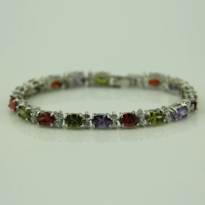 Detail of silver bracelet featuring multi-colored oval zircon stones and micro-inlays