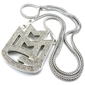 Macro view of iced out hip-hop musical note pendant with sparkling silver metal chain