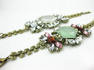 Detailed macro view of vintage bronze alloy floral bracelets with colorful crystals