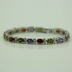 Detailed macro of multi-colored oval gemstone bracelet with sparkling zircon accents