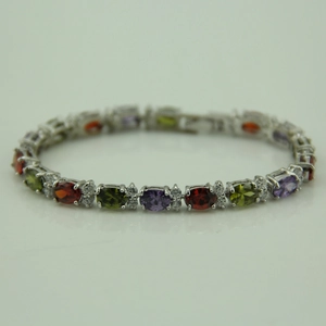 Detail of elegant silver bracelet featuring oval red, purple, and green zirconia stones
