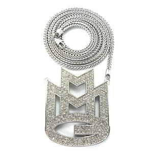 Macro shot of silver hip-hop pendant with iced-out crystals and heavy wheat chain