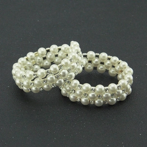 Exquisite layered pearl bracelet set with sparkling rhinestone spacers on black surface