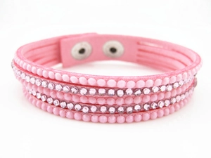 Detailed view of multilayer pink velvet bracelet with crystals and metallic studs