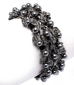 Macro view of vintage style gunmetal leaf bracelet with dark grey pearls and rhinestones