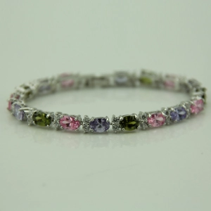 Detail of silver tennis bracelet with multi-color oval zircon stones and micro-pave crystals