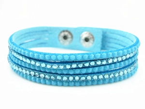 Detail of light blue velvet multilayer bracelet with sparkling rhinestones and metal snaps