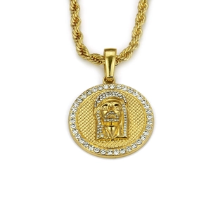 Macro shot of hip-hop gold medallion pendant with relief portrait and sparkling rhinestones