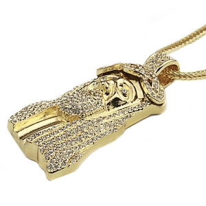 Macro shot of hip hop Jesus pendant with clear rhinestones and gold twisted rope chain