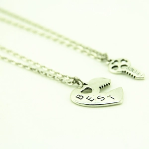 Vue macro du collier Best Friends avec pendentifs cœur et clé en argent poli