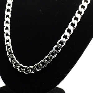 Detailed view of silver 12mm polished curb chain necklace on black jewelry display stand