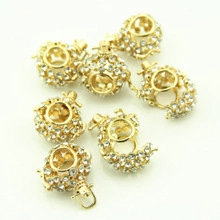 Close-up of gold plated hollow heart and moon charms with micro-pave crystals for DIY jewelry
