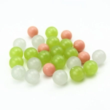 Macro shot of colorful hollow heart pendant beads in green and pink resin finishes