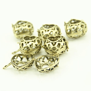 Antique bronze hollow heart-shaped locket pendants with intricate geometric patterns