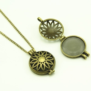 Detailed view of vintage hollow sunflower locket showing open and closed states