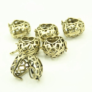 Set of six vintage bronze hollow heart locket pendants with intricate geometric patterns