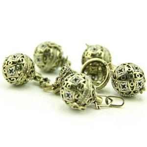 Detail of 6 vintage hollow metal aroma diffusers with intricate engravings and crystals