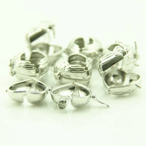 Detailed view of silver heart-shaped angel wing locket pendants for DIY jewelry making