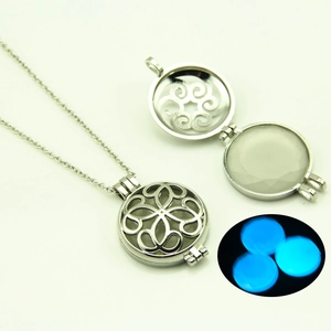 Collier pendentif ajouré argenté avec perle lumineuse bleue brillant dans le noir