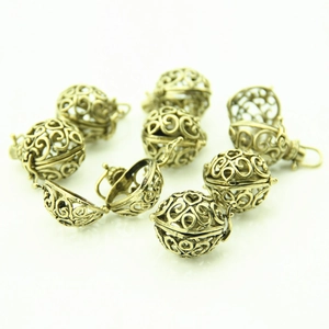 Macro detail of antique bronze hollow heart pendants with hinge for DIY jewelry making