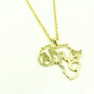Gold African map pendant necklace with cutout AFRICA letters on a delicate link chain