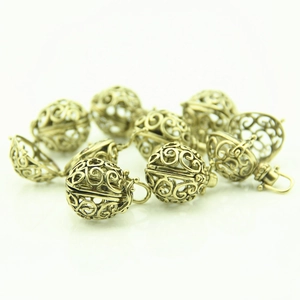 Detailed macro view of vintage hollow heart-shaped pendants for DIY necklaces
