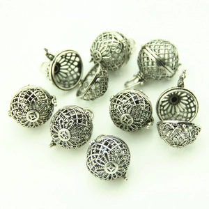 Detailed view of vintage silver hollow heart locket pendants for DIY jewelry making