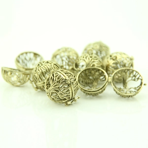 Detailed view of hollow antique bronze locket with tree of life pattern and hinge