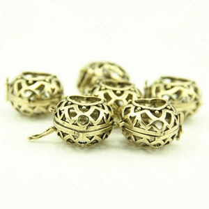 Close-up of hollow heart-shaped locket pendants in antique bronze for DIY jewelry making