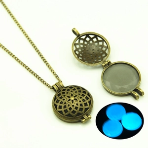 Detail of vintage hollow pendant with luminous moonstone showing blue glow in dark