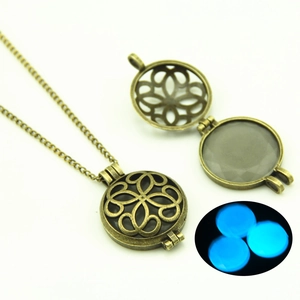 Detail of vintage bronze hollow necklace with a glowing blue moonstone effect