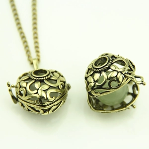 Vintage hollow heart glowing necklace with locket pendant and green bead in bronze finish