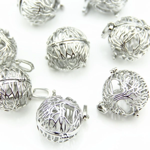Detailed view of silver tree of life locket pendants for aromatherapy essential oils