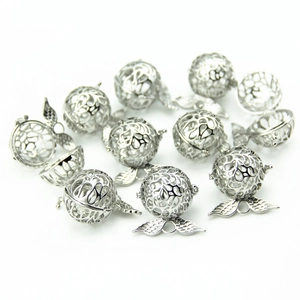 Locket necklace with angel wings and intricate hollow carvings in silver finish
