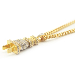 Macro shot of hip hop gold-toned power plug pendant necklace with iced-out rhinestones