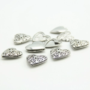Silver heart locket pendant with filigree hollow design and polished openable metal surface