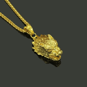 Detailed close-up of a golden wolf head pendant featuring intricate fur texture and a wheat chain